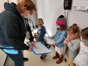 Giving the children an up close look at the oils seeping out of the orange zest.