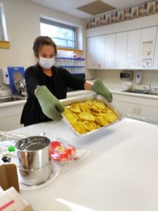 A different kitchen tool, her oven mitts.